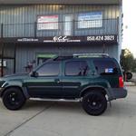 Nissan Xterra with American Outlaw wheels and Nitto Terra Grappler tires.